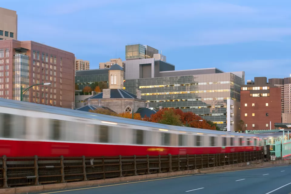 Blurred Red Line train in Boston passing on elevated rail.
